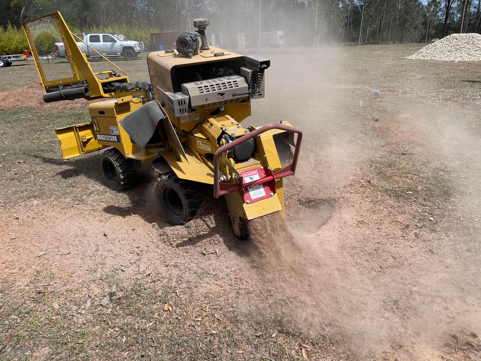 Professional stump grinding machinery at work with visible cost breakdown.